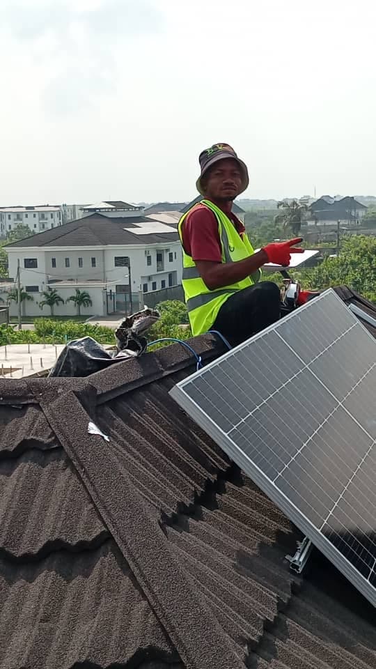Solar panels installed on a metal roof of a workshop.